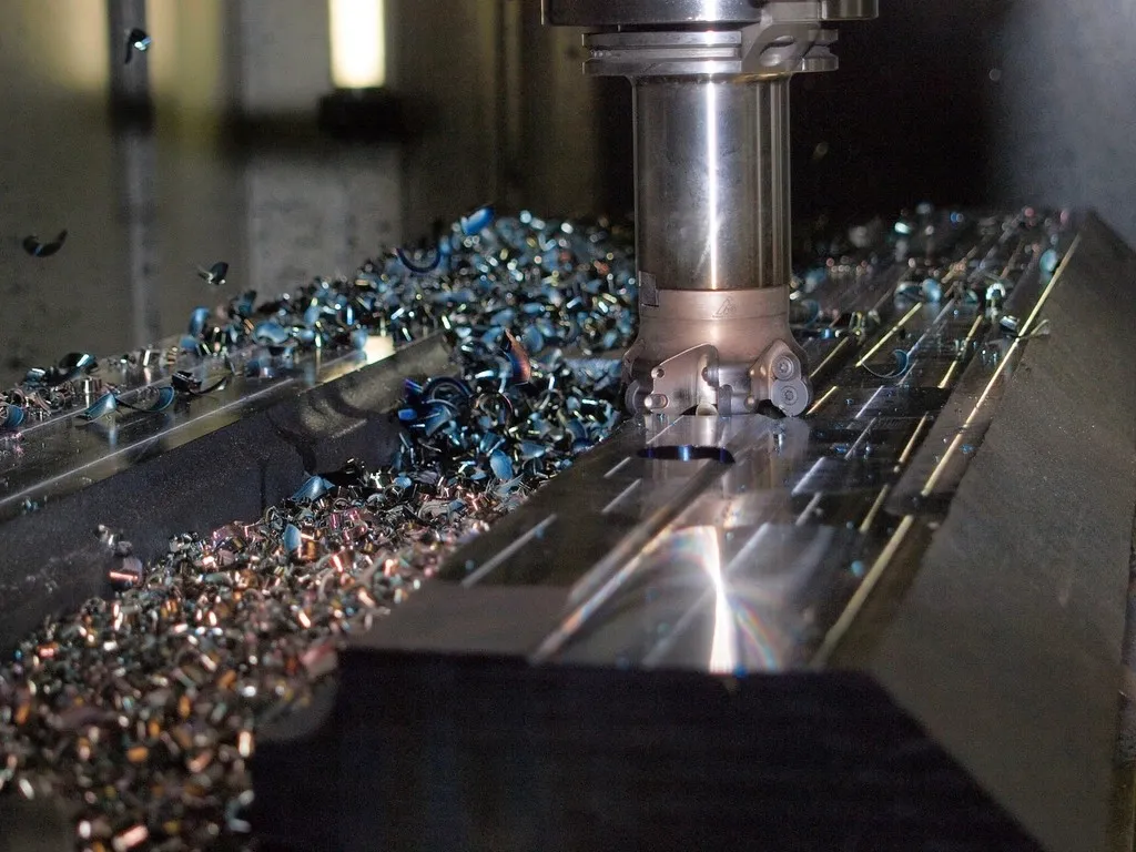 CNC milling cutter machining a metal block
