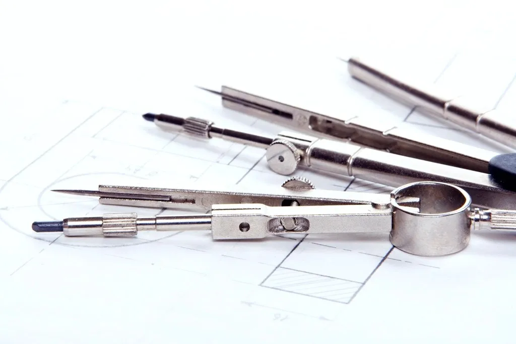 Drafting compasses on a technical drawing