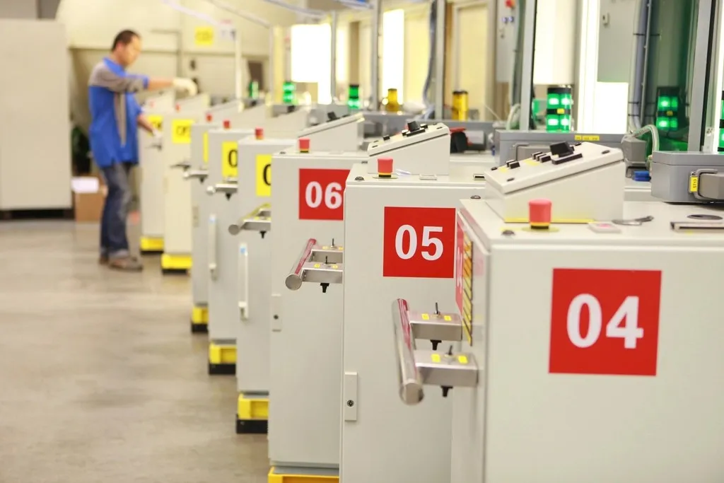 Row of numbered test stations with a technician