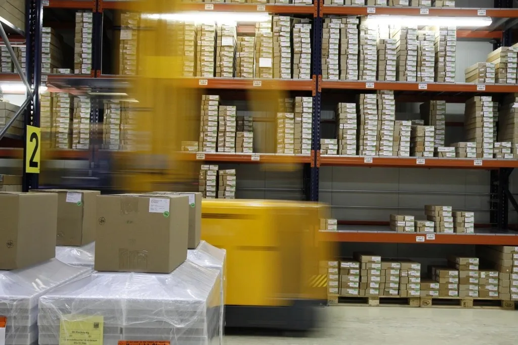 Warehouse shelves with a moving forklift
